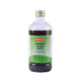 A bottle of Kandamkulathy Vasrishtam Ayurvedic medicine, featuring a clear glass bottle filled with dark liquid, a gold cap, and a green label with red and white text, set against a plain light purple background.